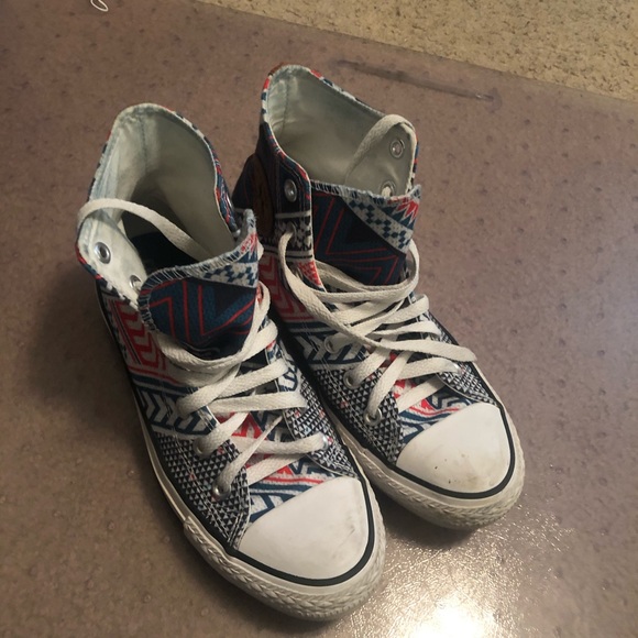 brown and blue leather converse